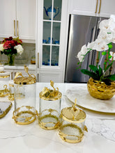 Load image into Gallery viewer, Glass and Gold Canister With Leaf Design